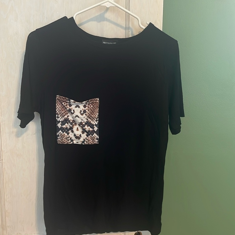 Black pretty little thing t-shirt with pattern front pocket.
